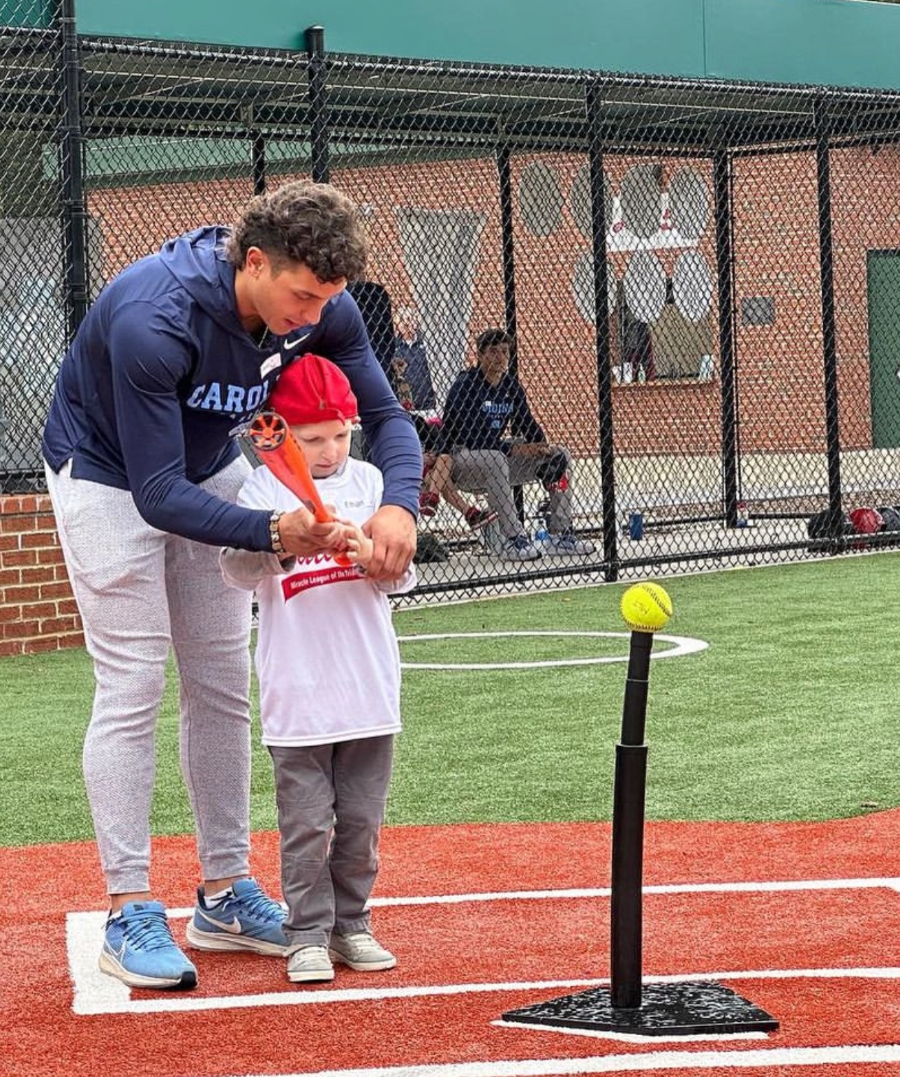 Johnny Castagnozzi helping a young player with his hitting.